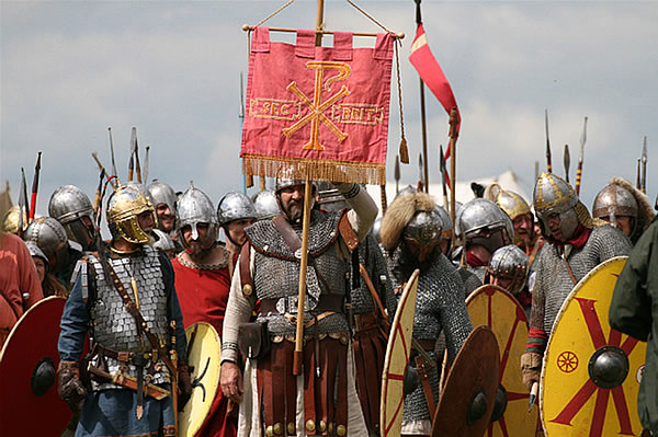 Soldiers waiting battle, one is holding a battle standard